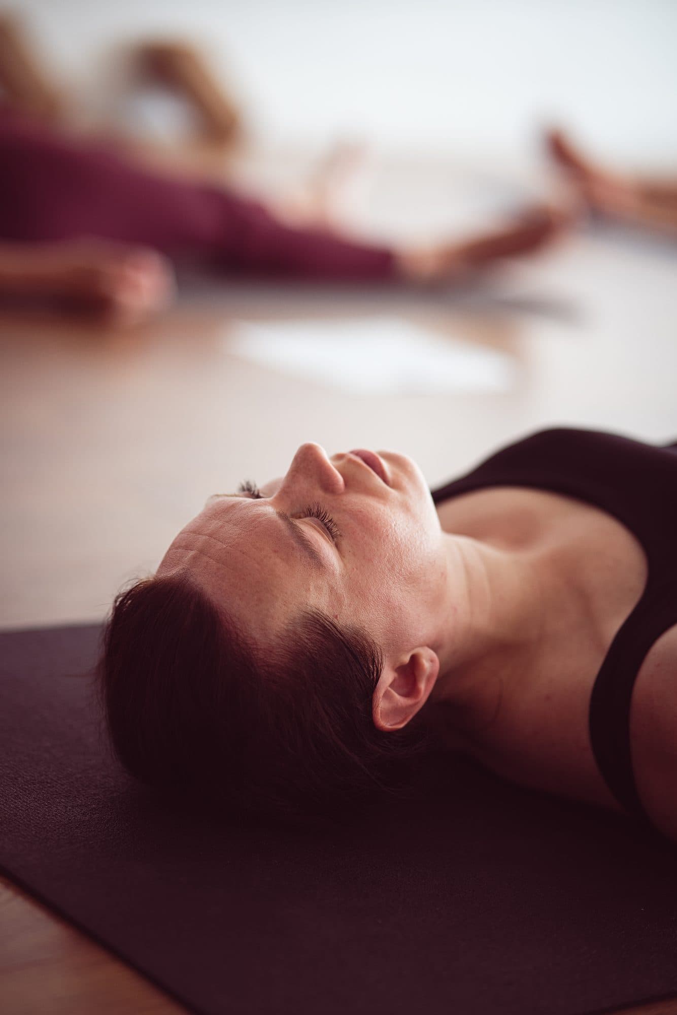 A student resting quietly in savasana